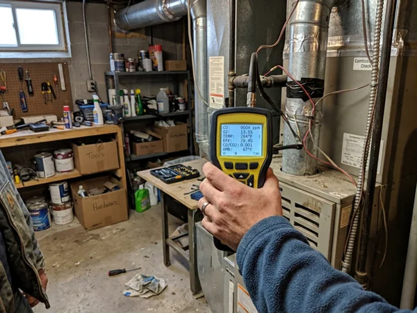 Combustion analyzer showing a verified CO reading after the repair