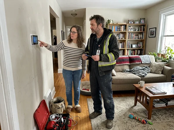 Homeowner and technician reviewing the thermostat schedule