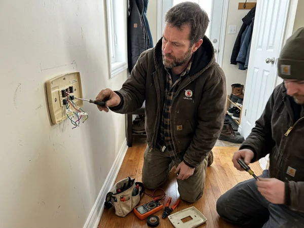 Thermostat backplate with low-voltage wiring being identified