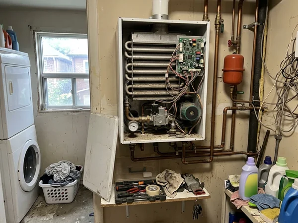 Condensing combi boiler with the front panel open for diagnosis